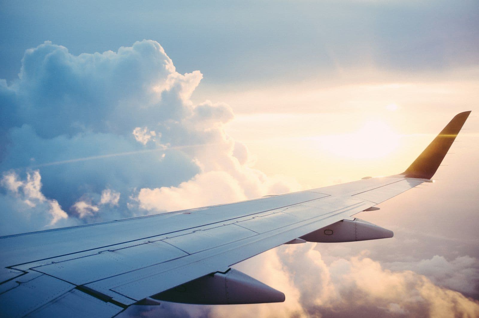 Airplane wing above the clouds during an international flight